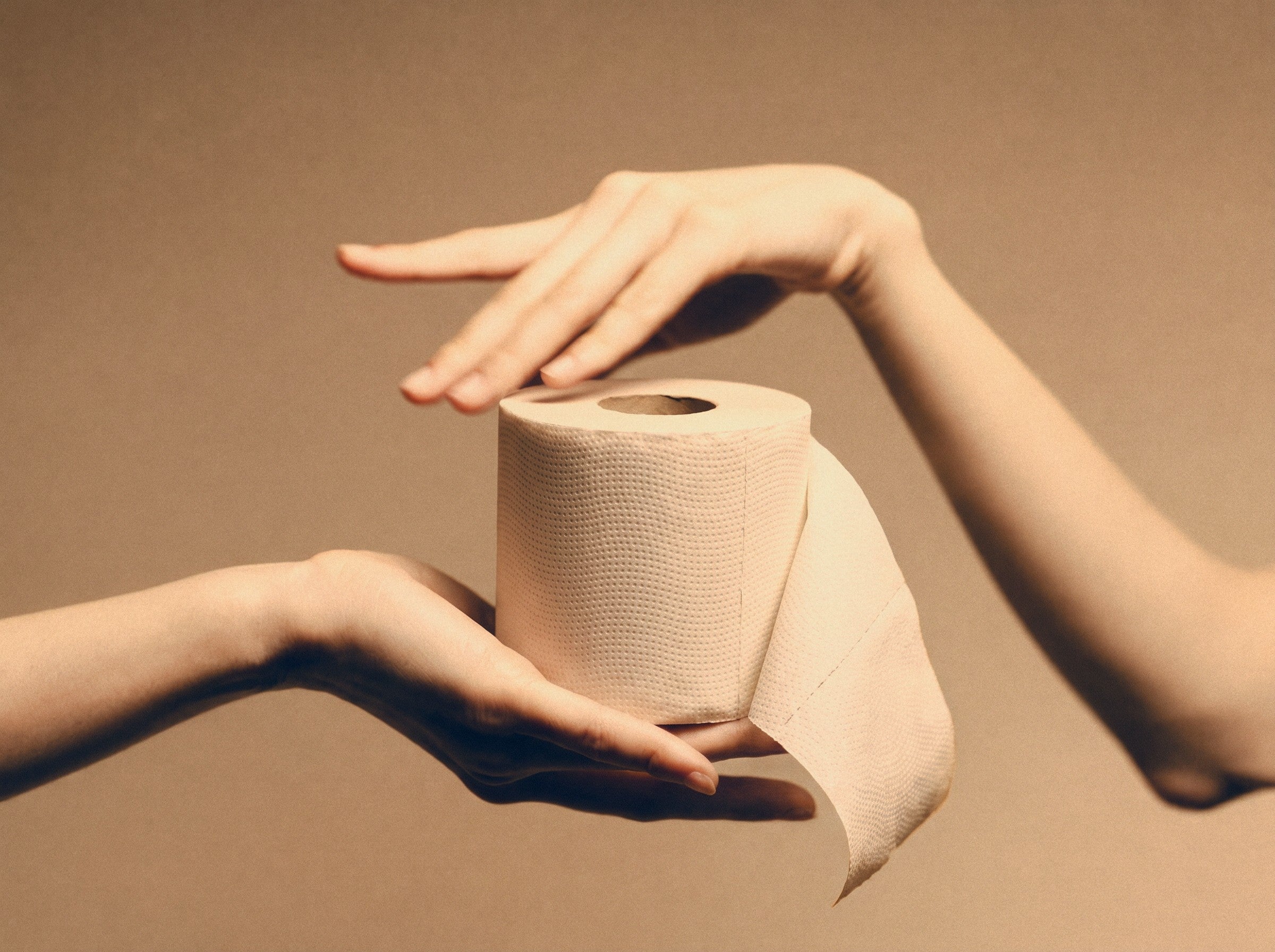 A roll of BAMBUM bamboo toilet paper held between two hands